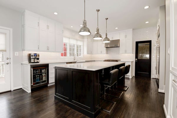 Fully white kitchen with black kitchen island contrast