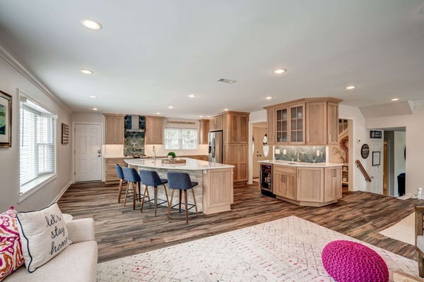 Light brown cabinetry in kitchen with dark, two-toned hard wood floors