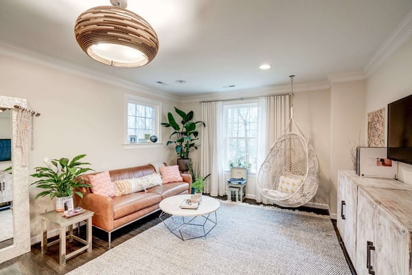 Boho styled living room with plants and chair swing
