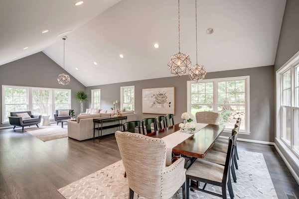 Cathedral ceiling in dining room and living room with circular pendant lights
