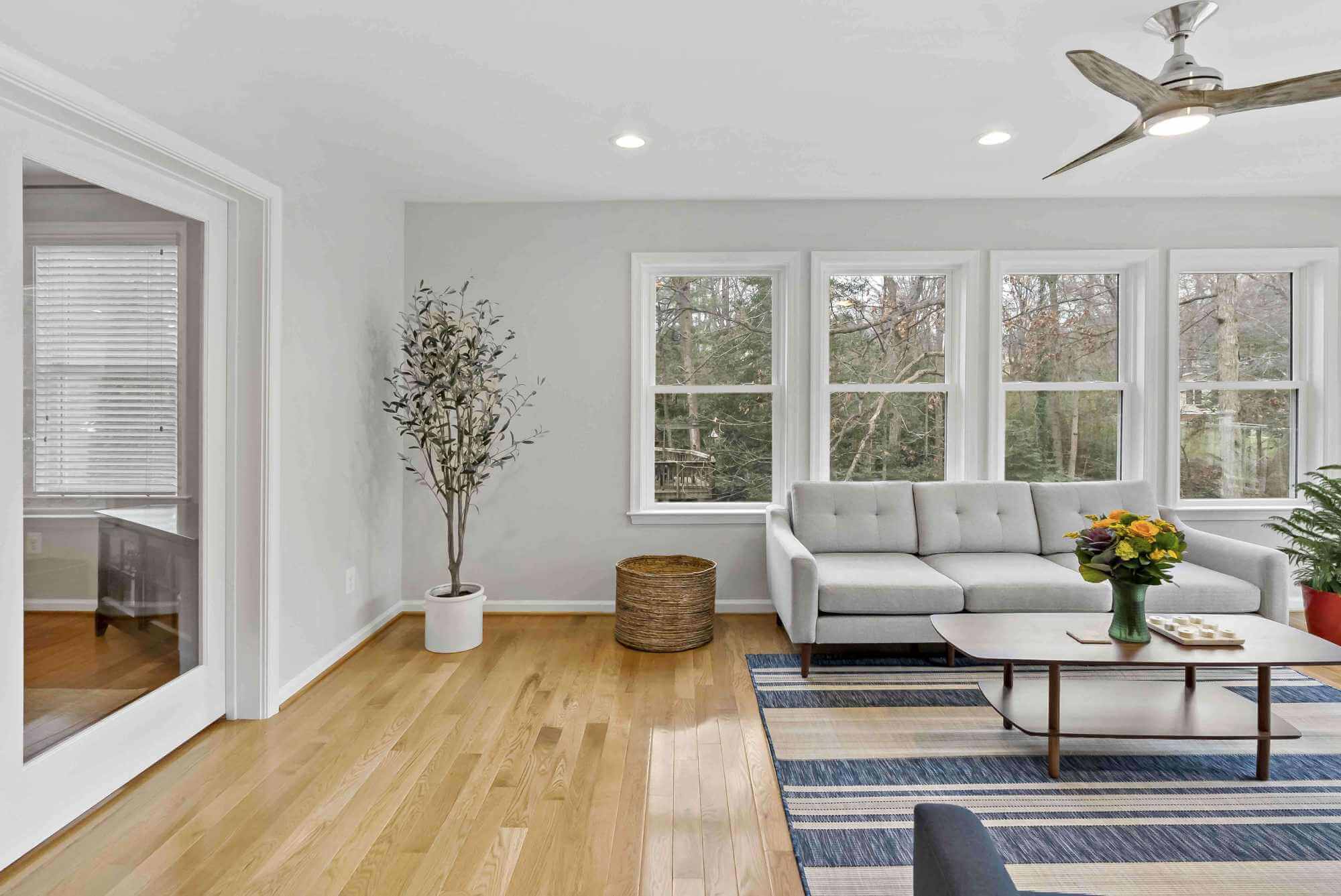 Hard wood floors in living room with large windows