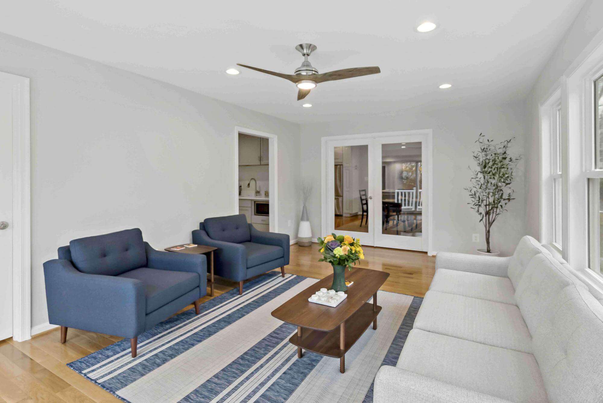 Sitting area with ceiling fan and white walls