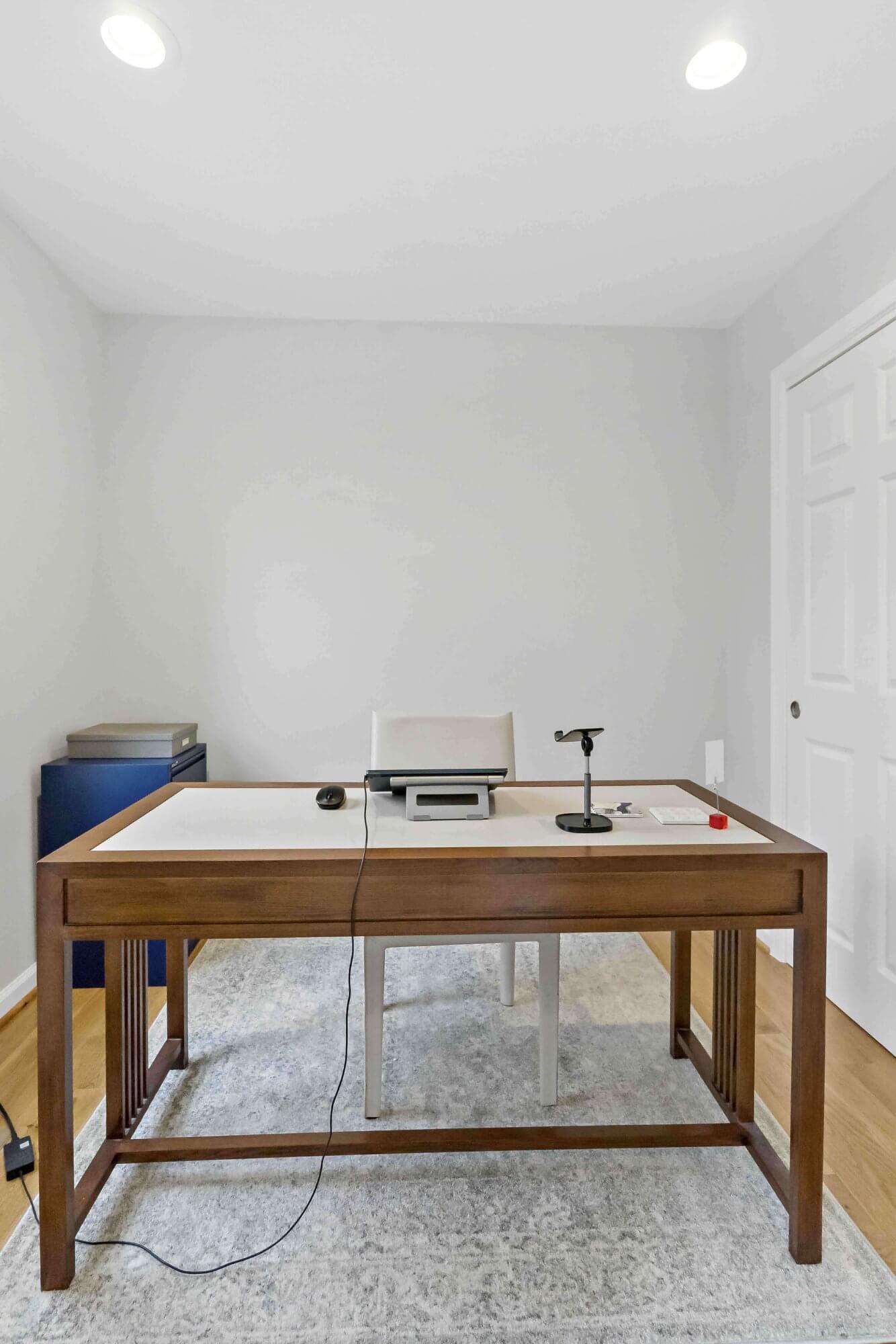 Desk and office room with white walls
