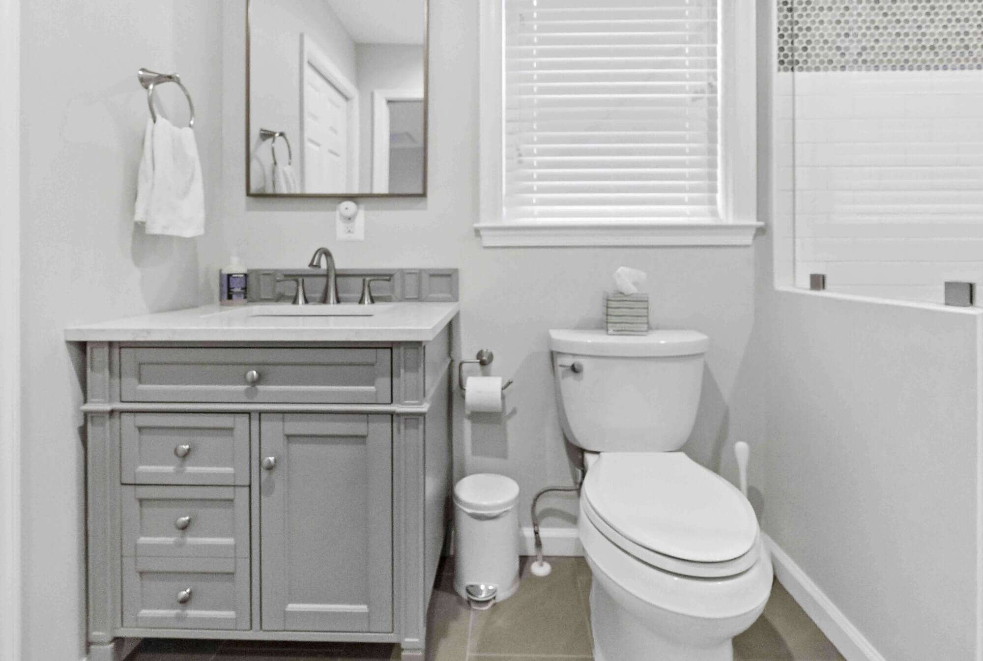 White bathroom with grey cabinets