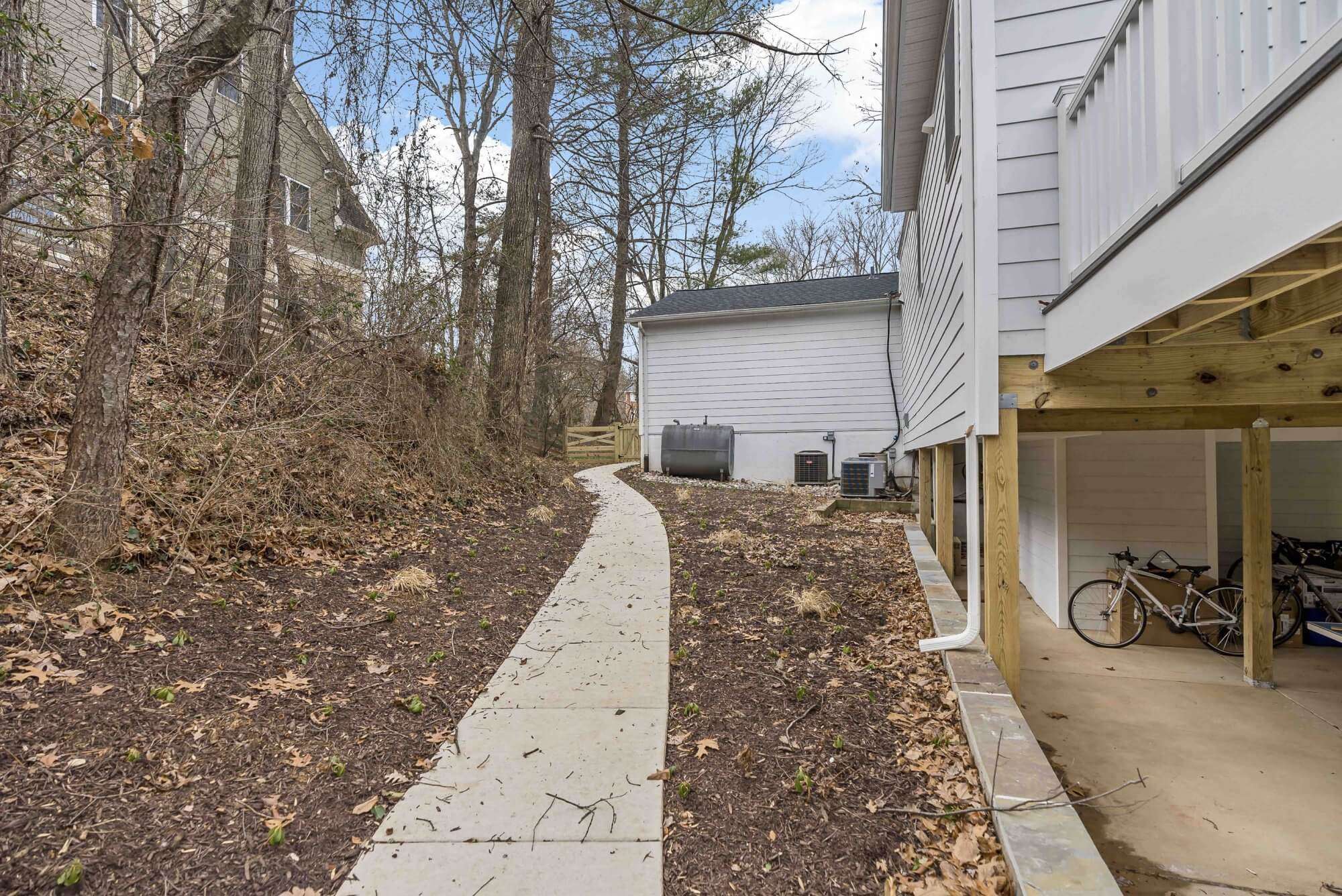 Cement sidewalk connecting from of house to back