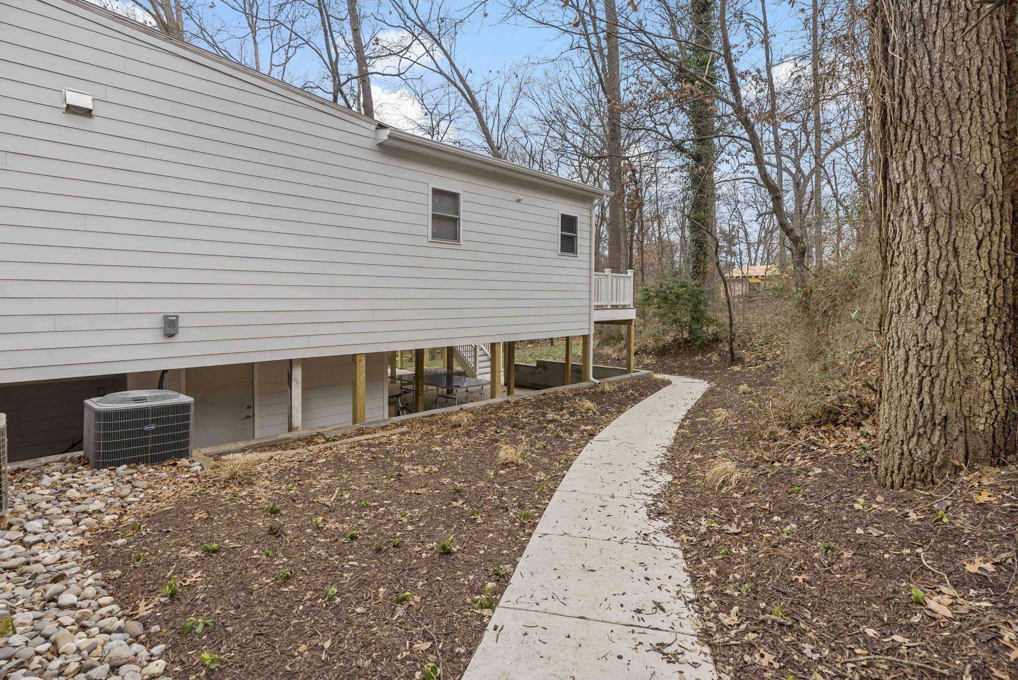 Walkway in backyard leading to porch