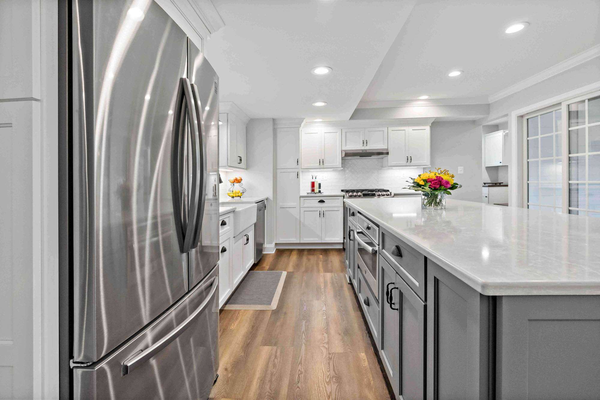 Silver fridge and white cabinets in kitchen