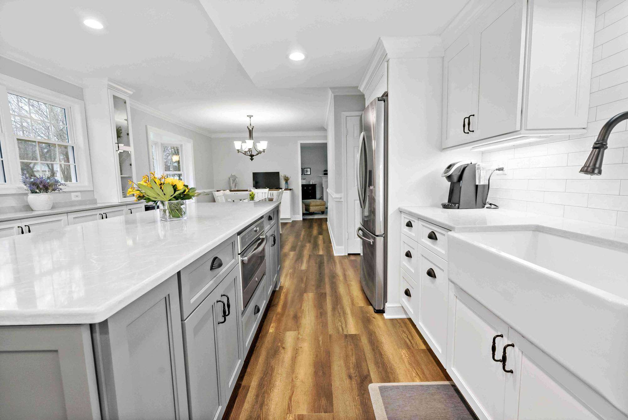 Black handles on white and grey cabinets in kitchen