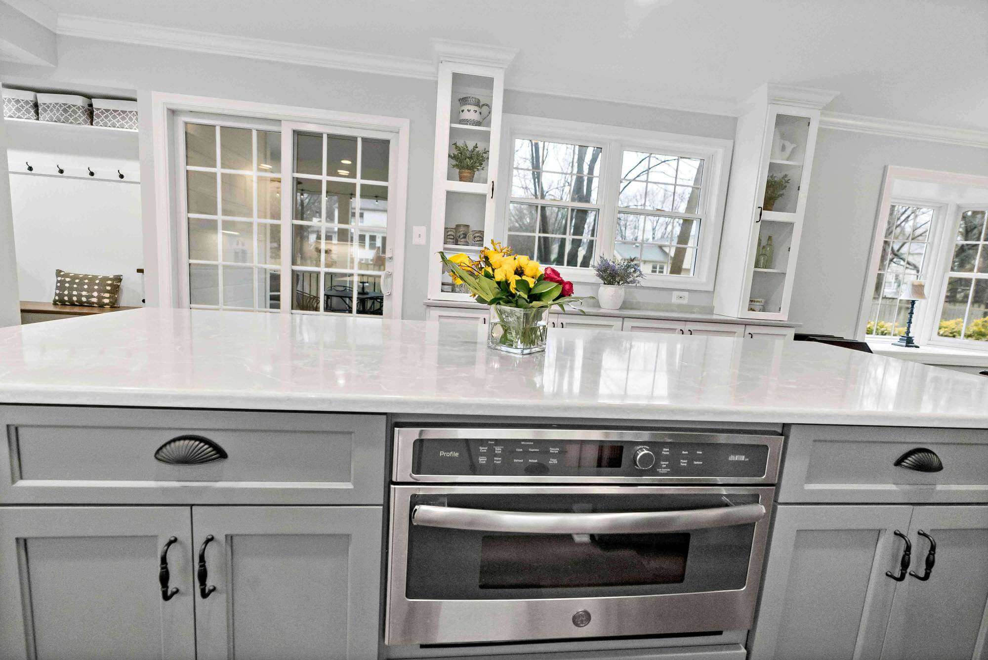 White countertop and grey cabinets on kitchen island