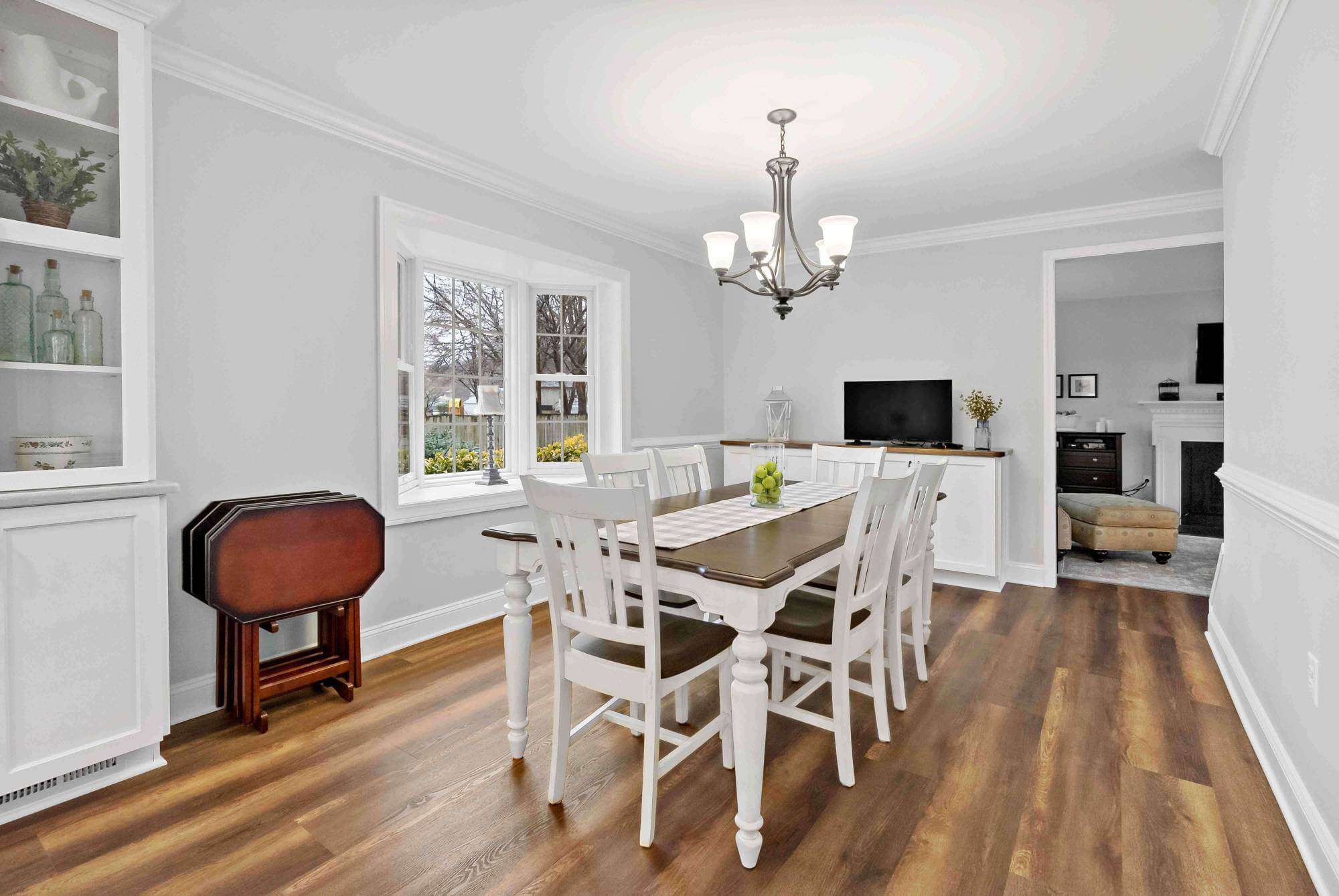 Hard wood flooring and white walls in dining room