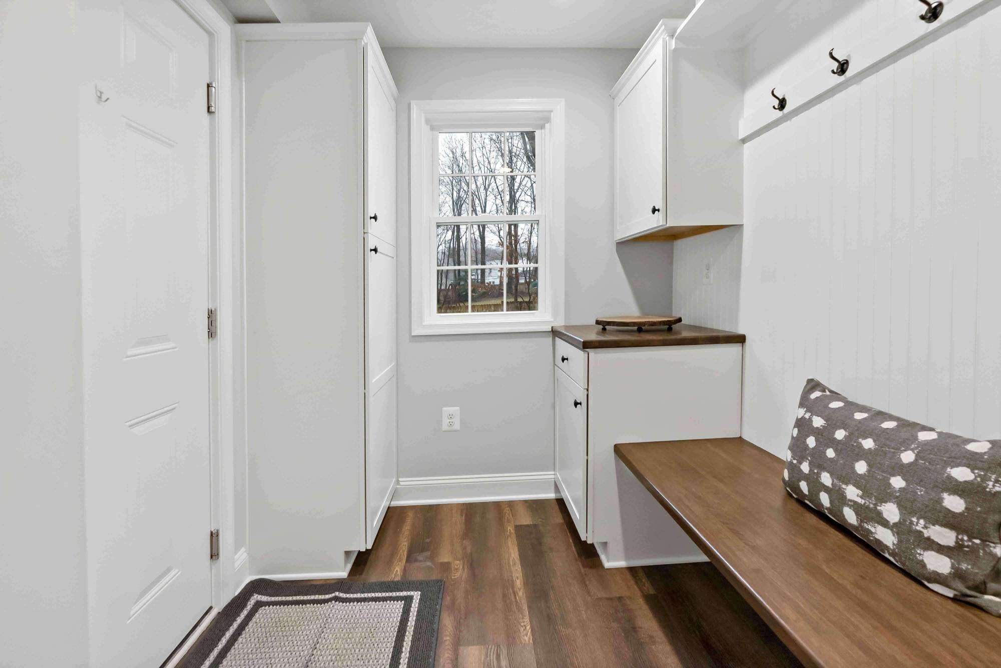 Hard wood floors in white mudroom