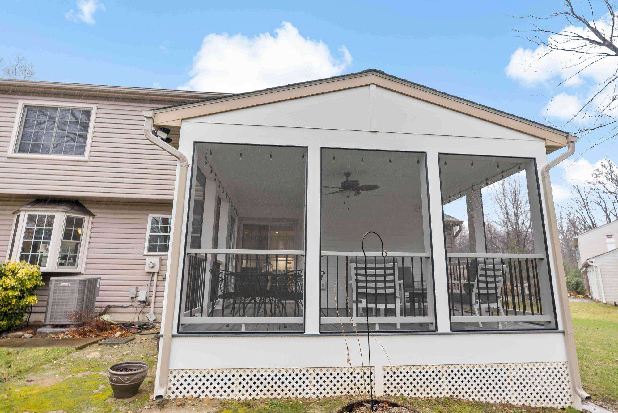 White square screened in porch with furniture