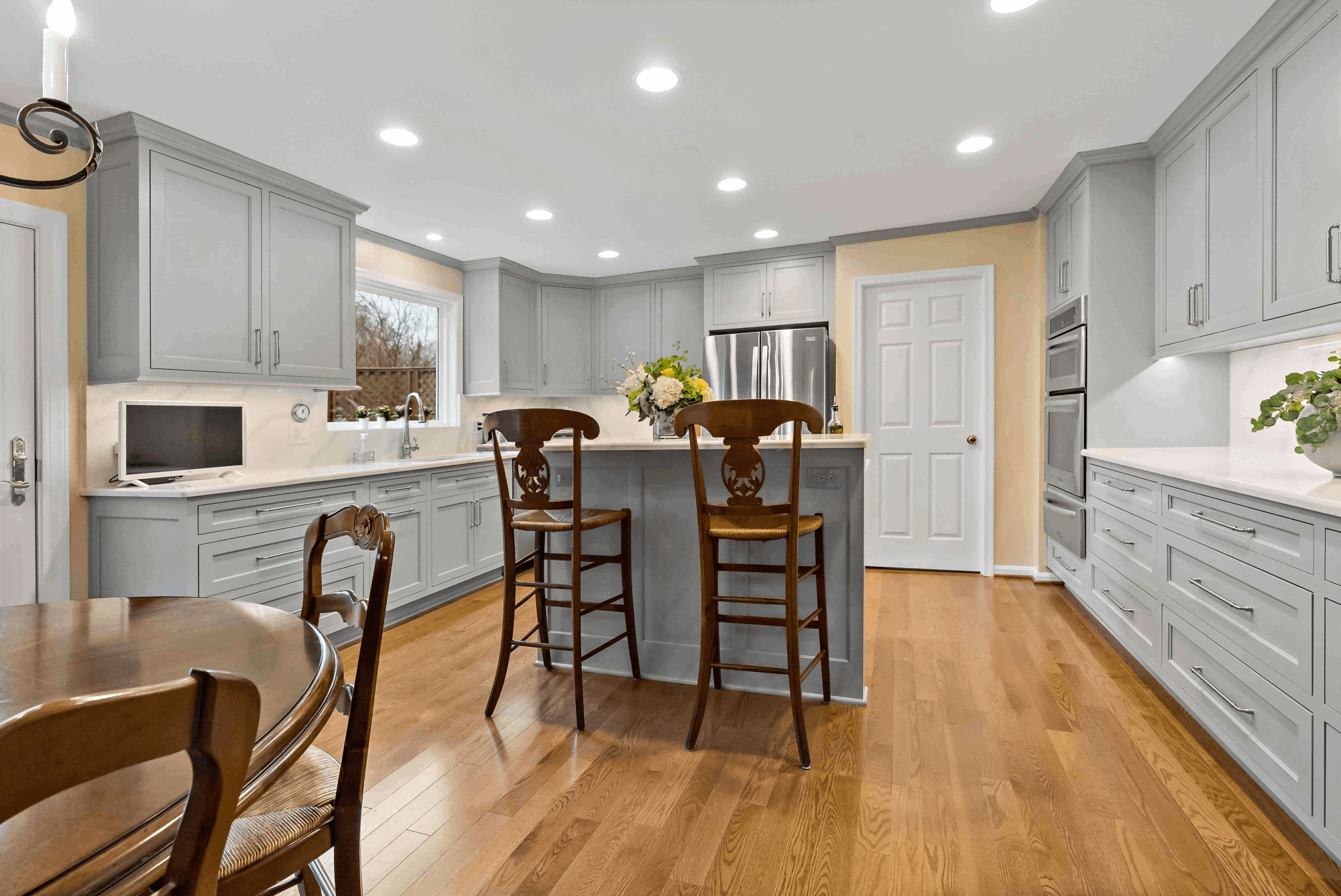 Wooden chairs and flooring in grey kitchen