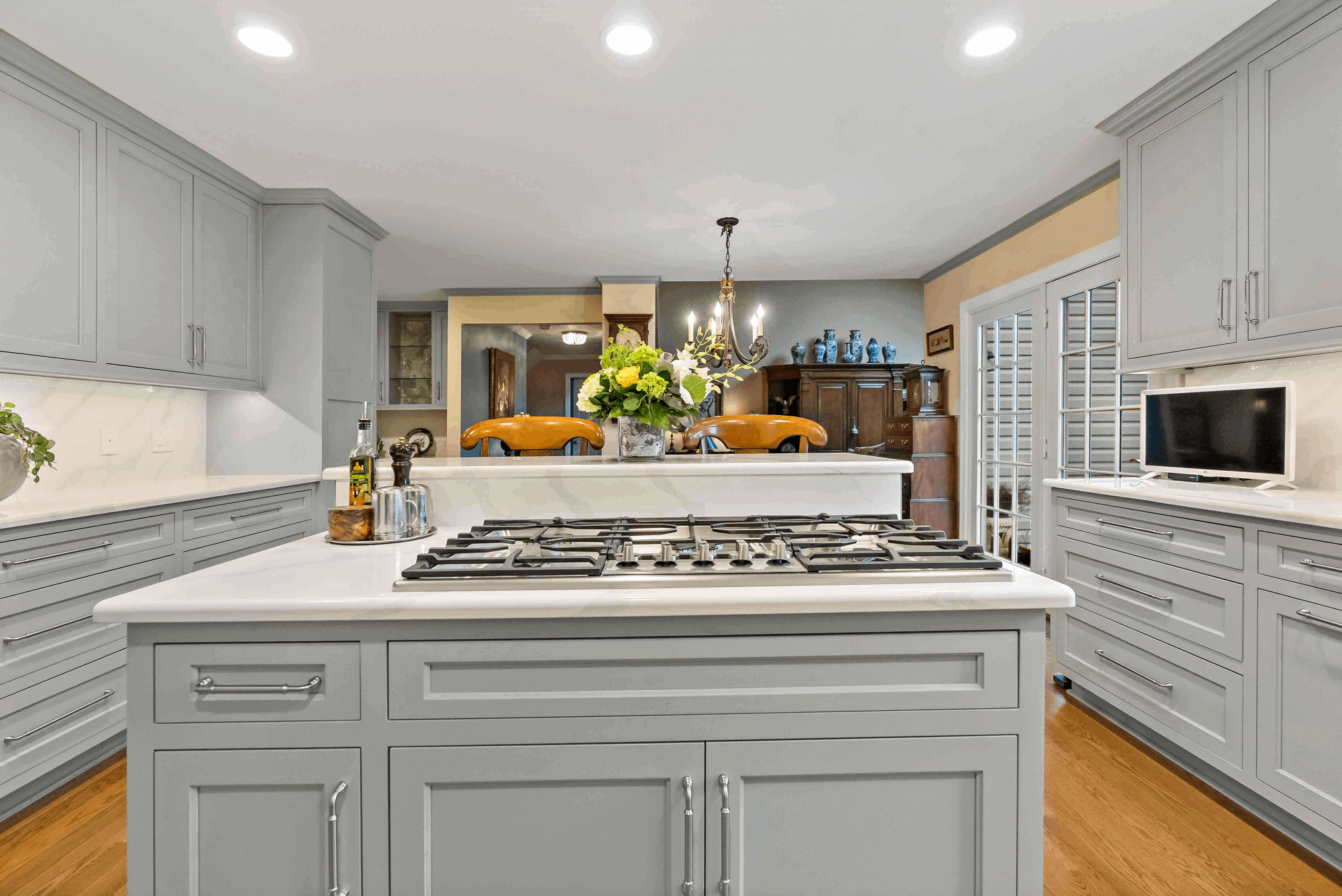 Gas fire stove top and grey cabinets in kitchen island
