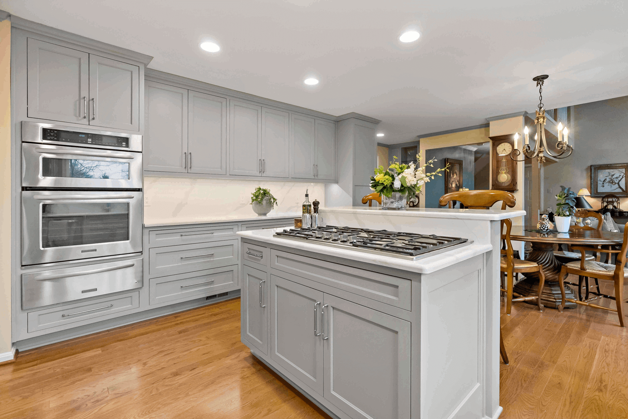 Grey cabinetry and hard wood floors in kitchen