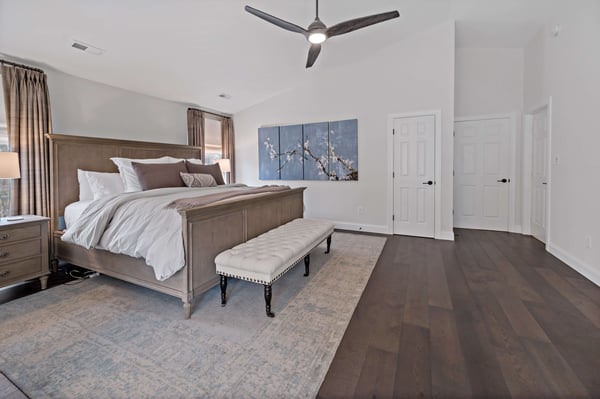 Ashburn bedroom with dark hardwood flooring and brown aesthetic