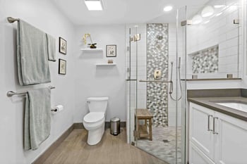 bathroom remodel in Annandale with curbless walk-in shower and multicolored brown tile