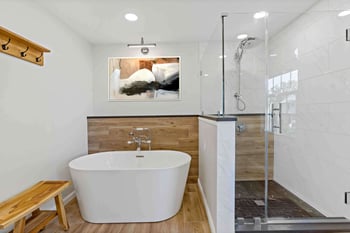 view of painting in bathroom behind tub