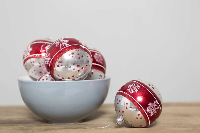 Christmas bauble decorations in a blue bowl on a kitchen table