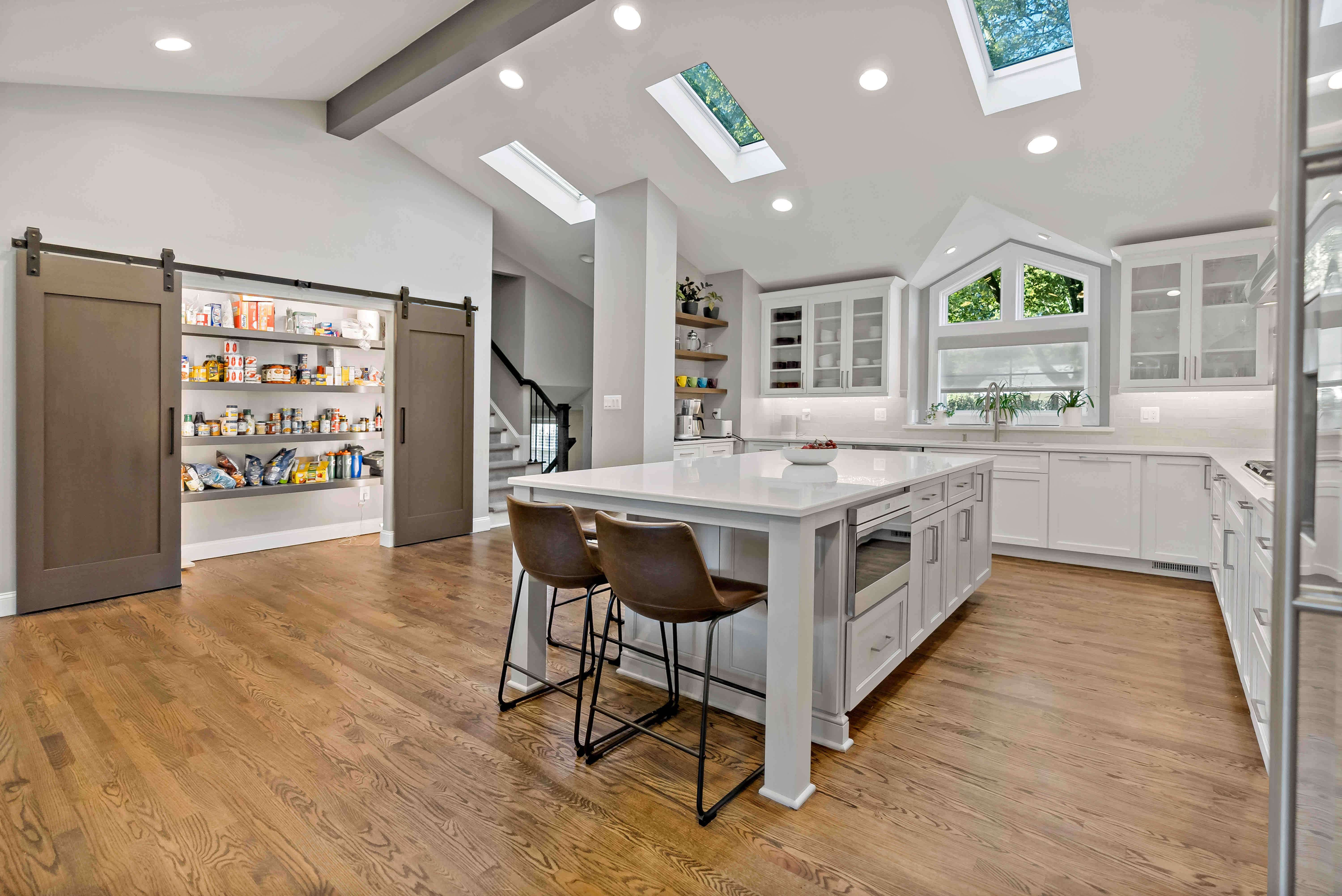 Large open kitchen with cathedral ceiling and skylights