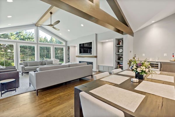 Spacious and airy dining room and living room with large windows and a cathedral ceiling