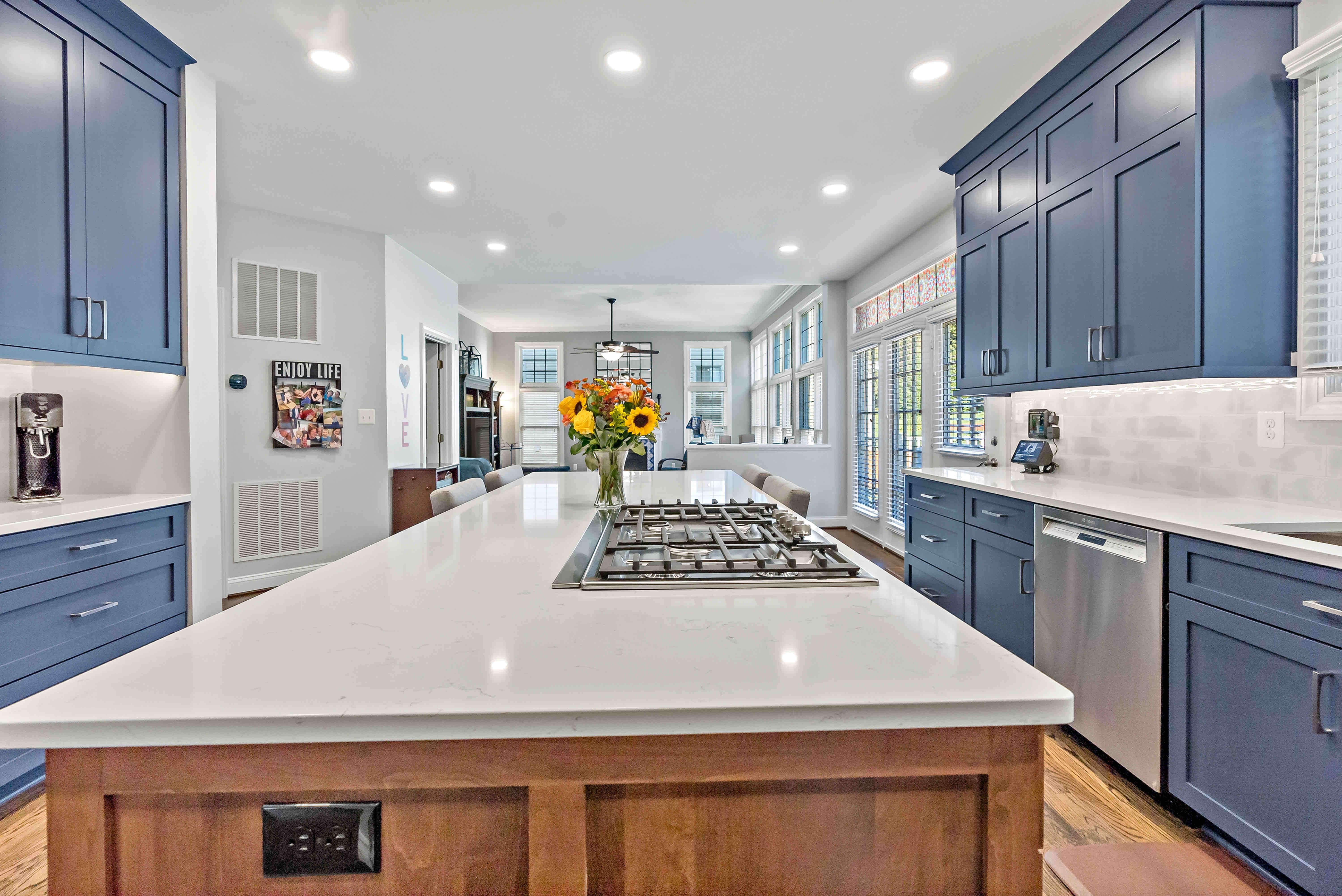Blue cabinets and white countertops in kitchen