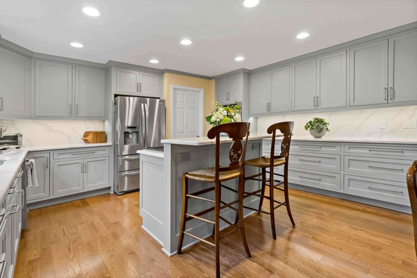 Light grey, contemporary kitchen remodel with island and ample storage cabinets