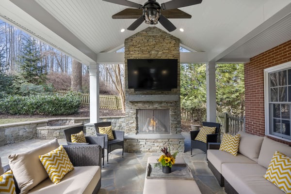 Gorgeous grand stone fireplace with cathedral shiplap ceiling above patio