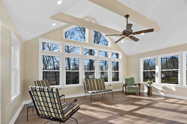 Sunroom with large windows and beige walls and hard wood floors