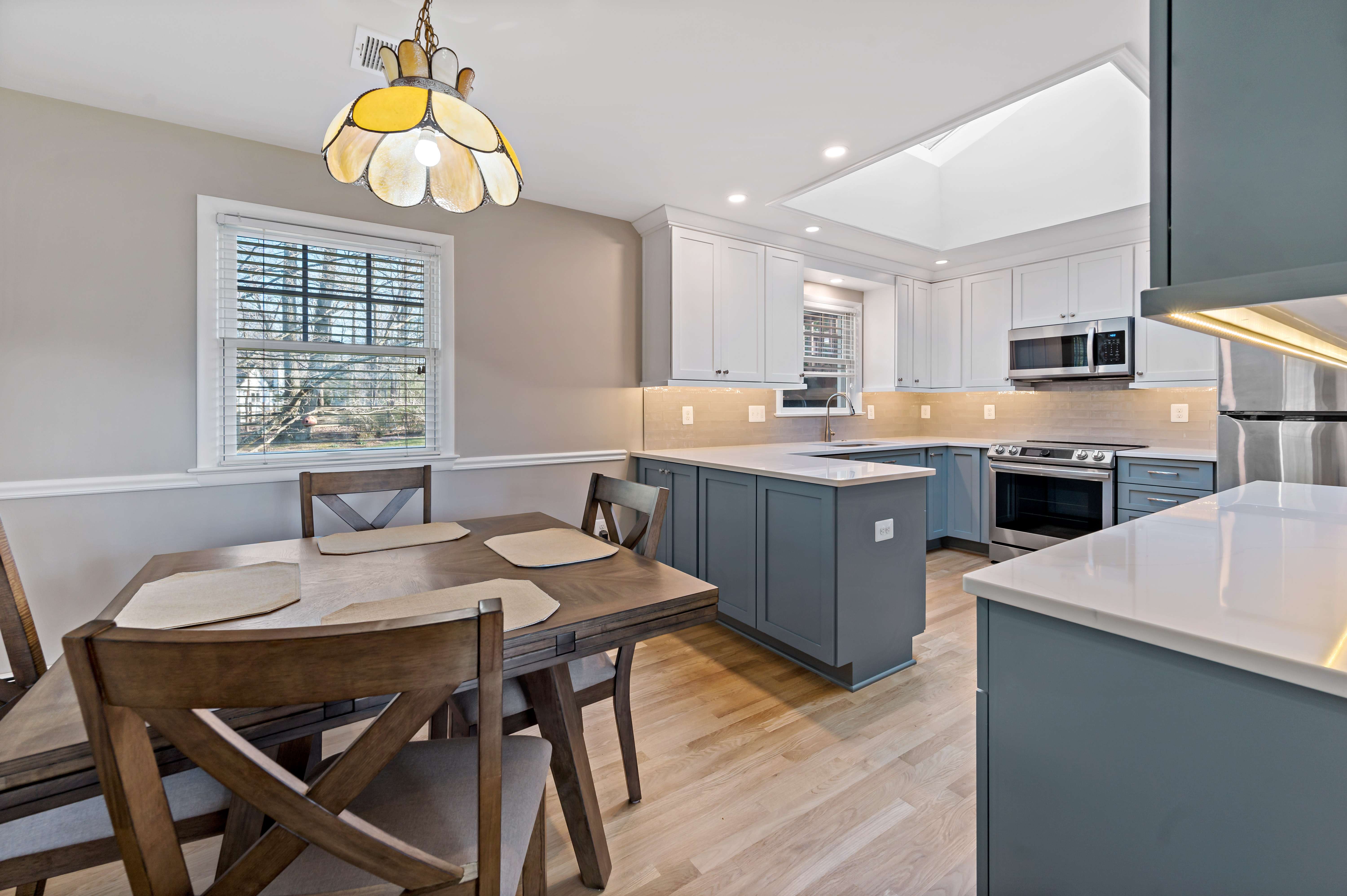 Light blue cabinets and white countertops in kitchen