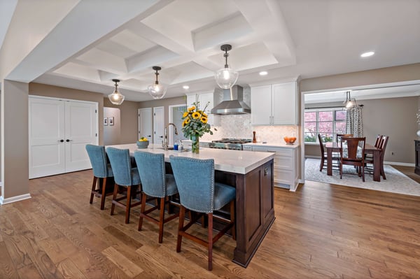 Kitchen with coffered ceiling and blue fabric island chairs