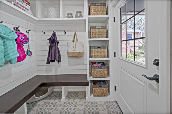 White mudroom with hooks, bench, and shelves for outdoor clothing