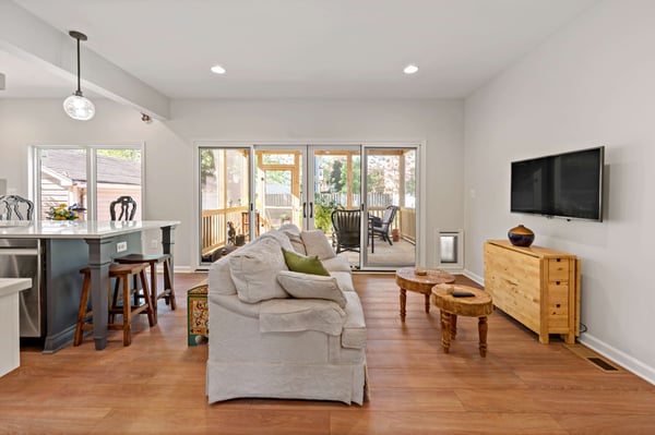 Open concept kitchen and living room with double door access to patio