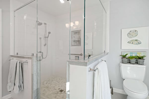 White bathroom with large walk-in shower and glass walls