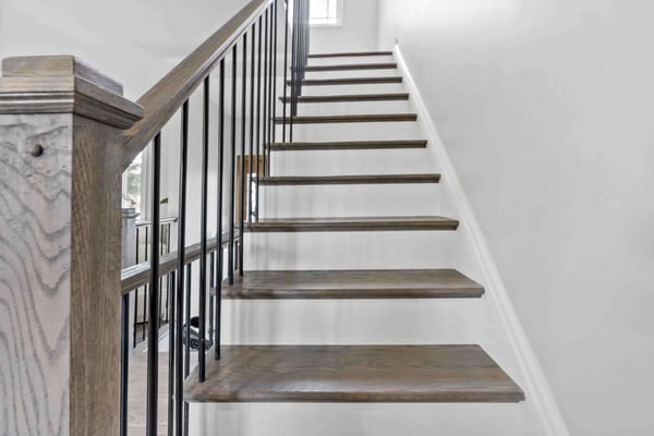 Dark brown and white staircase with black rails