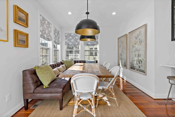 Dining room table with chairs and couch for seating