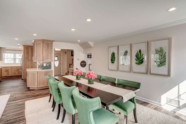 Chic dining room with green fabric chairs and wood table