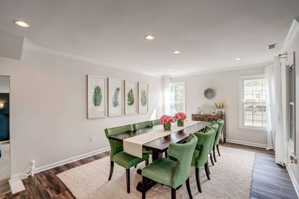 Dining room with green comfy chairs and area rug