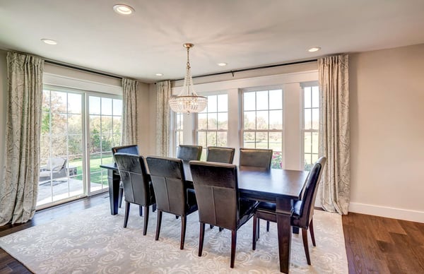 Elegant dining room with large table and windows and curtains
