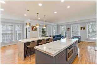 Two kitchen islands with seating and food prep space