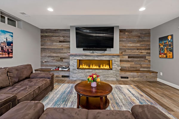 Wood flooring and walls by fireplace in rustic basement
