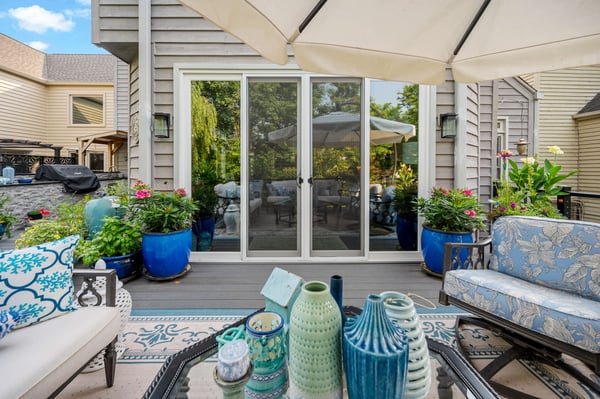 Double sliding door to access outdoor patio with blue furniture