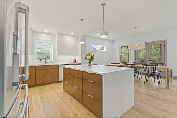 Modern and clean kitchen with brown cabinetry and white countertops