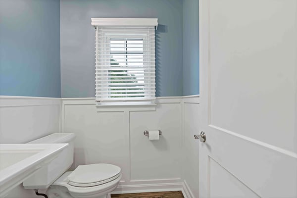 Simple, small blue and white bathroom with natural lighting