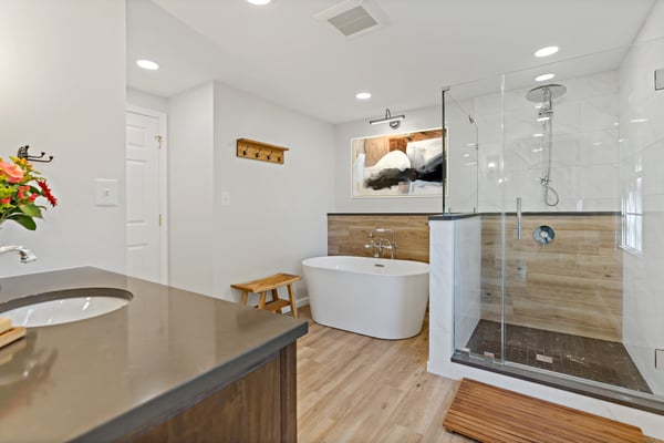 Scandinavian style bathroom with light wood accents, sleek design, and modern bathtub and shower