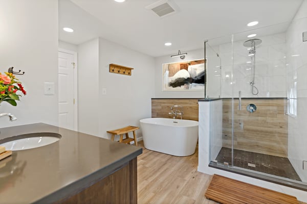 Full bathroom with wood accents, walk-in shower with glass walls, and standalone tub