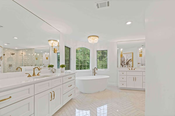 Elegant full master bathroom with stand-alone tub and cream aesthetic