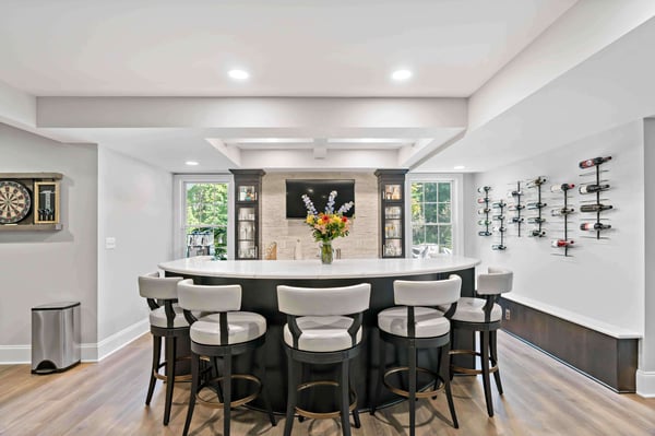 Basement bar with semicircle counter and wine rack on wall