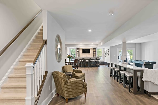 Open basement with ample seating and different zones for entertainment