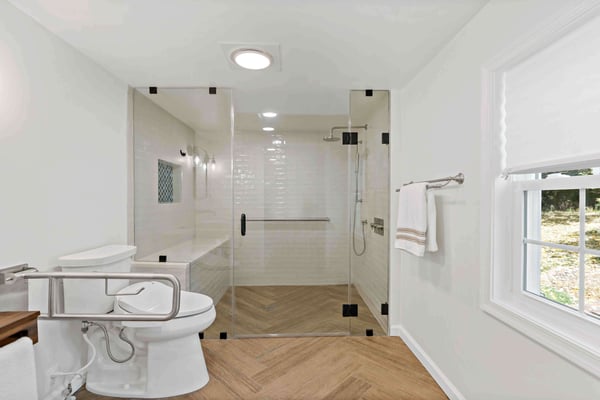 ADA bathroom with grab bars and curbless shower with bench